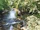 Rocky creek flows through lush green trees at 3300 Windy Ridge Se Pkwy # 1110, Atlanta, GA 30339