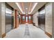 Modern hallway with elevators and wood and stone finishes at 3300 Windy Ridge Se Pkwy # 1110, Atlanta, GA 30339
