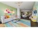 Open concept living area with a large sectional sofa and colorful rug at 3300 Windy Ridge Se Pkwy # 1110, Atlanta, GA 30339