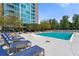 Community pool with lounge chairs and building view at 3300 Windy Ridge Se Pkwy # 1110, Atlanta, GA 30339