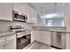 Modern kitchen with white cabinets, granite counters, and stainless steel appliances at 262 Eva Way, Cartersville, GA 30121