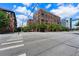 Brick building at a street corner with green trees at 115 W Peachtree Nw Pl # 301, Atlanta, GA 30313