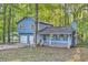 Two-story light blue house with attached two-car garage at 34 Powder Brook Ct, Dallas, GA 30157