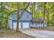 Two-story light blue house with attached two-car garage at 34 Powder Brook Ct, Dallas, GA 30157