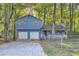 Two-story light blue house with attached two-car garage at 34 Powder Brook Ct, Dallas, GA 30157