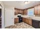 Efficient kitchen featuring wood cabinets and black appliances at 34 Powder Brook Ct, Dallas, GA 30157