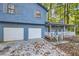Two-story light blue house with attached two-car garage at 34 Powder Brook Ct, Dallas, GA 30157