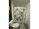 Clean bathroom with shower and leafy shower curtain at 563 Se Memorial Se Dr # 401, Atlanta, GA 30312