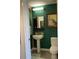 Small bathroom with pedestal sink, toilet and green walls at 563 Se Memorial Se Dr # 401, Atlanta, GA 30312