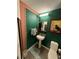 Small bathroom with pedestal sink, toilet and green walls at 563 Se Memorial Se Dr # 401, Atlanta, GA 30312