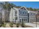 Two-story townhome with gray siding, black fence, and driveway at 5174 Longview Run, Decatur, GA 30035