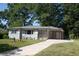 Ranch home with gray brick exterior, landscaping, and carport at 2790 Miriam Ln, Decatur, GA 30032