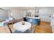 Modern kitchen with white cabinets, stainless steel appliances, and a blue island at 2790 Miriam Ln, Decatur, GA 30032