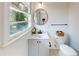 Small bathroom with single vanity, toilet and updated fixtures at 2790 Miriam Ln, Decatur, GA 30032