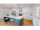 Modern kitchen with white cabinets, stainless steel appliances, and a blue island at 2790 Miriam Ln, Decatur, GA 30032