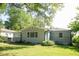 Side view of charming house with gray siding, mature trees, and a spacious yard at 2790 Miriam Ln, Decatur, GA 30032