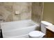 Clean bathroom with a bathtub and tile surround at 9931 Mancunian Way, Douglasville, GA 30135