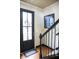 Entryway with black door and staircase at 9931 Mancunian Way, Douglasville, GA 30135