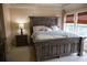 Spacious Primary bedroom with large bed, nightstand and window at 9931 Mancunian Way, Douglasville, GA 30135