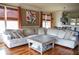 Spacious living room with hardwood floors, large sectional sofa, and a coffee table at 9931 Mancunian Way, Douglasville, GA 30135