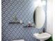 Stylish powder room with patterned wallpaper and pedestal sink at 9931 Mancunian Way, Douglasville, GA 30135