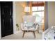 bedroom with rocking chair and window at 9931 Mancunian Way, Douglasville, GA 30135