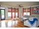 Light-filled living room with hardwood floors and sectional sofa at 9931 Mancunian Way, Douglasville, GA 30135
