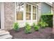 Landscaped front yard with brick facade and bushes at 9931 Mancunian Way, Douglasville, GA 30135