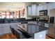 Updated kitchen with gray cabinets, granite counters, and island at 9931 Mancunian Way, Douglasville, GA 30135