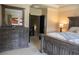 Bedroom with large dresser, king-size bed, and access to upper level at 9931 Mancunian Way, Douglasville, GA 30135