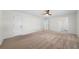 Spacious bedroom with carpet, ceiling fan, and ample closet space at 3573 Clubhouse Ln, Conyers, GA 30094