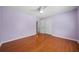 Light purple walls and hardwood floors in this spacious bedroom at 3573 Clubhouse Ln, Conyers, GA 30094