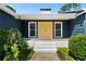 Inviting entryway with a bright yellow door and landscaping at 3573 Clubhouse Ln, Conyers, GA 30094