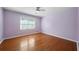 Spacious bedroom with hardwood floors and a ceiling fan at 3573 Clubhouse Ln, Conyers, GA 30094