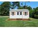White storage shed with double doors and window shutters at 3573 Clubhouse Ln, Conyers, GA 30094