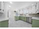 Updated kitchen with light green cabinets and marble-look floors at 3573 Clubhouse Ln, Conyers, GA 30094