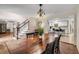 Spacious dining room with hardwood floors, kitchen access, and staircase view at 1195 Vineyard Se Dr, Conyers, GA 30013