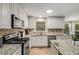 Well-equipped kitchen with white cabinets, granite countertops, and stainless steel appliances at 1195 Vineyard Se Dr, Conyers, GA 30013