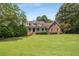 Brick home with a large front yard and lush landscaping at 1195 Vineyard Se Dr, Conyers, GA 30013