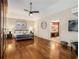 Large main bedroom with hardwood floors, a ceiling fan, and an ensuite bathroom at 1195 Vineyard Se Dr, Conyers, GA 30013