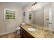 Well-appointed bathroom with granite countertops and a large vanity mirror at 1195 Vineyard Se Dr, Conyers, GA 30013