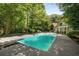Expansive backyard with a sparkling swimming pool and lush greenery at 1195 Vineyard Se Dr, Conyers, GA 30013