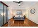 Spacious main bedroom with hardwood floors, a ceiling fan, and ample closet space at 1195 Vineyard Se Dr, Conyers, GA 30013