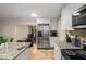 Modern kitchen with stainless steel appliances and granite countertops. View of dining room at 1195 Vineyard Se Dr, Conyers, GA 30013