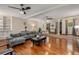 Large living room with hardwood floors, sectional sofa, and built-in shelving at 1195 Vineyard Se Dr, Conyers, GA 30013