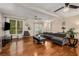Living room with hardwood floors, sectional sofa, and access to backyard at 1195 Vineyard Se Dr, Conyers, GA 30013