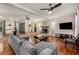Bright living area with hardwood floors, sectional sofa, and a stone fireplace at 1195 Vineyard Se Dr, Conyers, GA 30013
