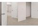 A carpeted hallway with several doors at 1029 Cades Walk, Lawrenceville, GA 30045