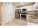Modern kitchen with stainless steel appliances and granite countertops at 6635 Shapiro Ct, Stone Mountain, GA 30087