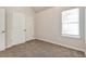 Well-lit bedroom featuring double door closets and neutral decor at 6635 Shapiro Ct, Stone Mountain, GA 30087